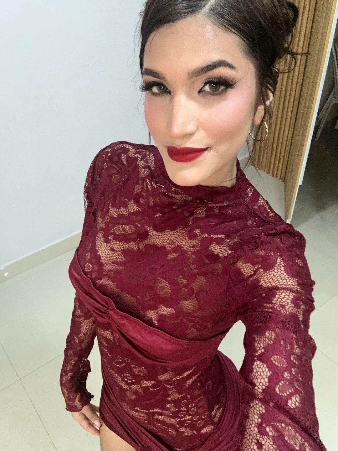 A woman in a burgundy lace dress with red lipstick, illustrating the BazooChat section of the comparison